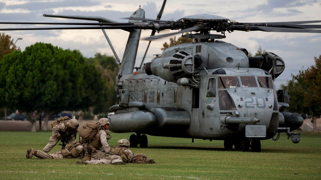 Marines with 2nd Battalion, 7th Marine Regiment, based out of Marine Corps Air Ground Combat Center Twentynine Palms, Calif., provide security in front of a CH-53E Super Stallion helicopter during a non-combatant evacuation exercise at Kiwanis Park in Yuma, Ariz., Friday, Oct. 16, 2015. The Marines reinforced initial ground units preparing for the evacuation.