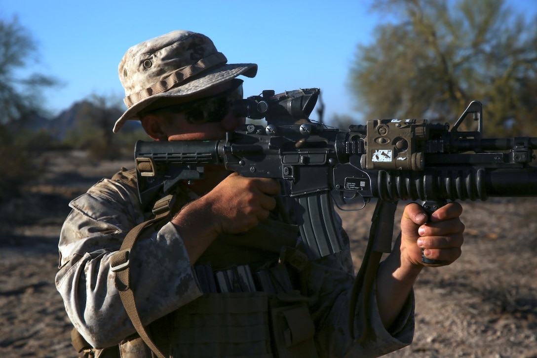 Lance Cpl. Henry Mesker, a rifleman assigned to Company E, 2nd Battalion, 7th Marine Regiment, 1st Marine Division, searches for enemy targets after a simulated attack in the defense  during Talon Exercise 1-16 at Marine Corps Air Station, Yuma, Ariz., Oct. 13, 2015. The training took place at Baker’s Peak, a rugged desert training area located on the approximately 1,700,000 acre Barry M. Goldwater Range and was part of a larger event called Talon Exercise, which focused on offensive and defensive operations in desert and urban environments.