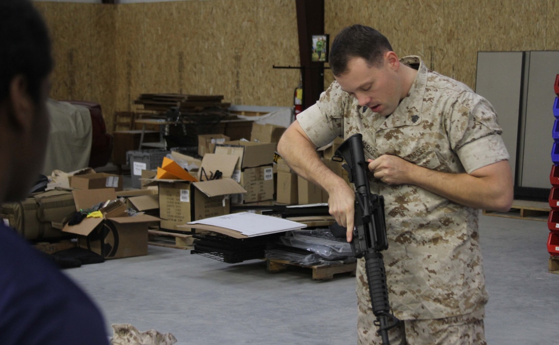 U.S. Marine Corps Sgt. Ronald L. Richards, a recruiter with Marine Corps Recruiting Sub- station Aberdeen, former marksmanship instructor, and Free Port, Illinois, native, demonstrates how to properly clear a weapon to a group of poolees during a pool function at Quantico Tactical in Aberdeen, North Carolina, Oct. 10, 2015. The Marines taught the poolees proper weapons handling, aiming and marksmanship to give them a unique experience and teach them skillsets that will be useful at recruit training. (U.S. Marine Corps photo by Sgt. Dwight A. Henderson/Released)