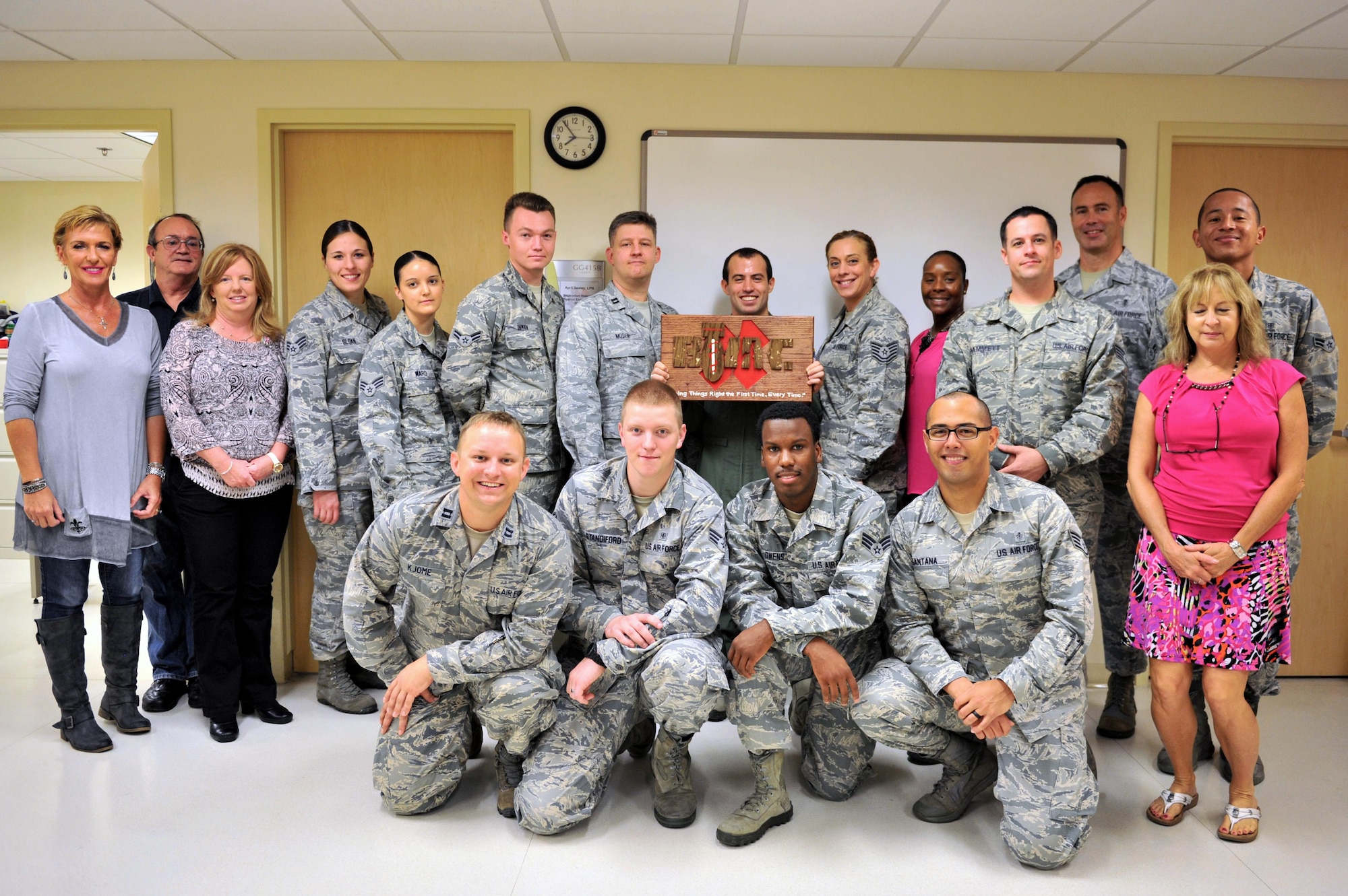 Members of the Base Operation Medicine Cell take a group photo after hosting a grand opening at the Keesler Medical Center, Sept. 28, 2015, Keesler Air Force Base, Miss. The Keesler BOMC is working to adjust Air Force healthcare by standardizing Public Health Assessments, Deployment Health Assessments, flight physicals and clearance physicals in order to make direct patient care more accessible, personal and timely. This clinic is the first of its kind in the Air Force. (U.S. Air Force photo by Airman 1st Class Duncan McElroy)