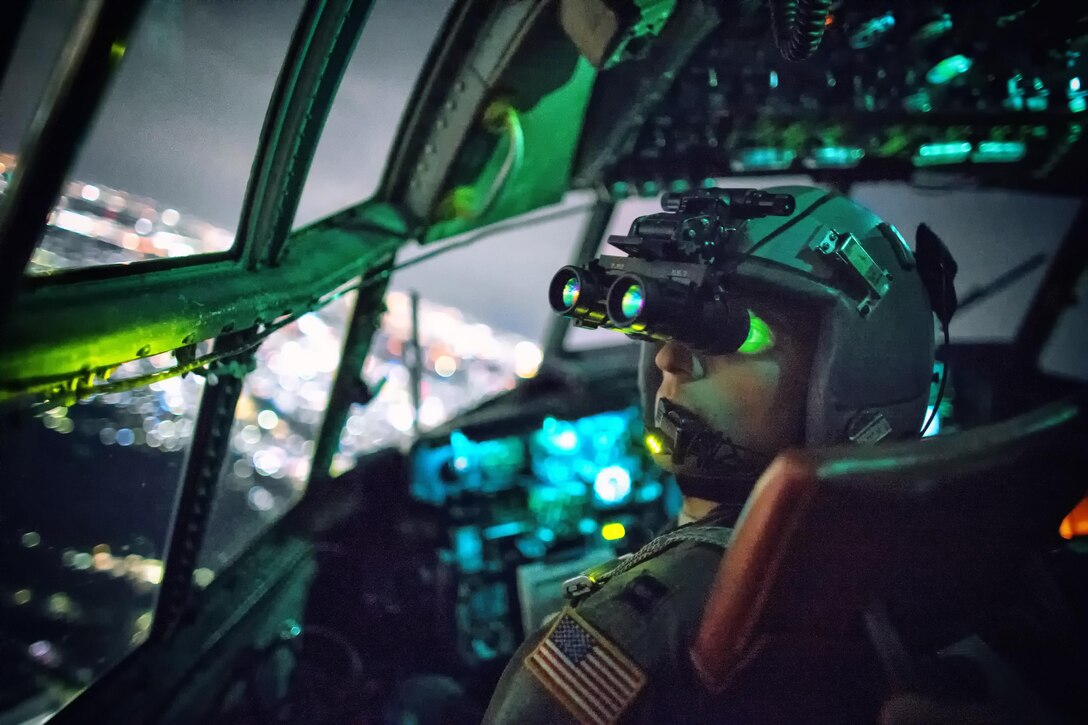 U.S. Air Force Capt. Thomas Bernard performs a visual confirmation with night vision goggles during a training mission over the Kanto Plain in Japan, Oct. 14, 2015. Bernard is a C-130 Hercules pilot with the 36th Airlift Squadron. U.S. Air Force photo by Yasuo Osakabe