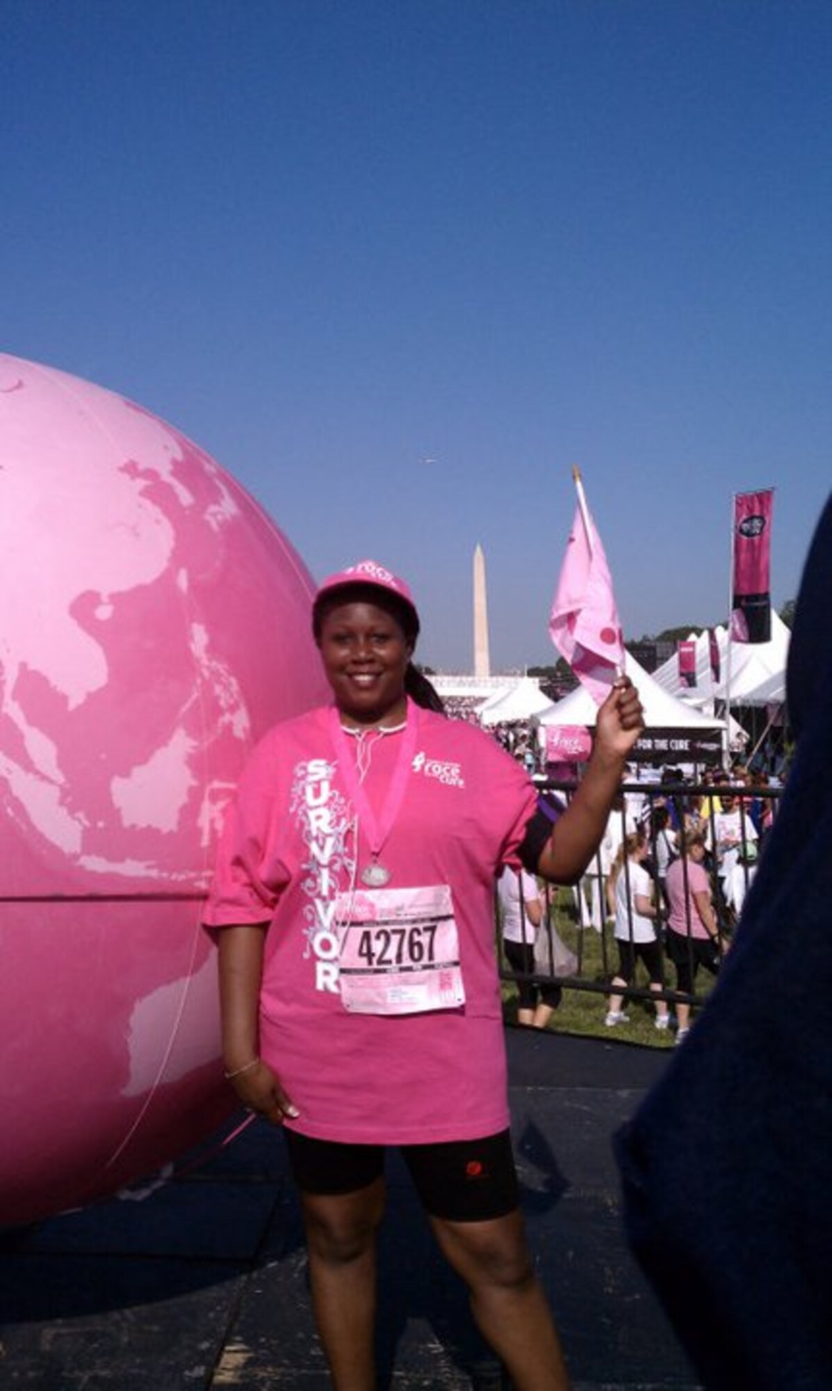Chief Master Sergeant Yolanda Jennings raises a flag at the Susan G. Komen 5K Race for the Cure in Washington, D.C., in 2011. (Chief MSgt. Yolanda Jennings)