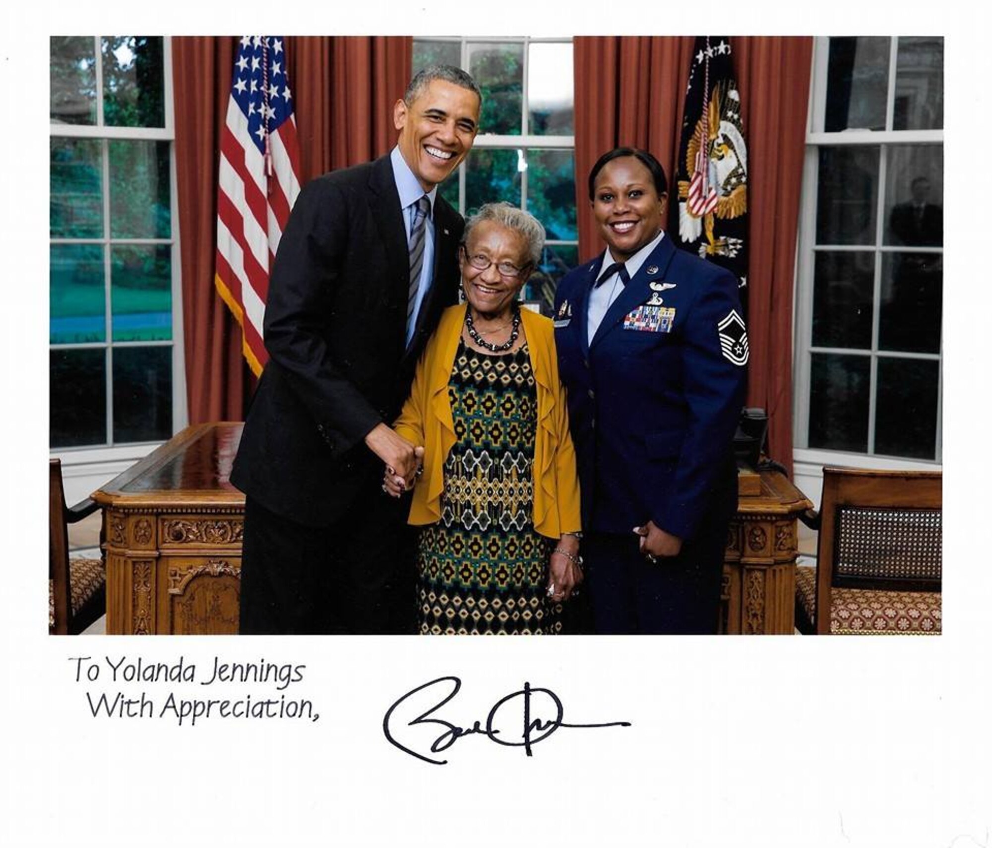 President Barack Obama holds hands with Chief Master Sergeant Yolanda Jennings’ grandmother, Alee Walker, during an Oval Office photograph in 2014. (Chief MSgt. Yolanda Jennings)