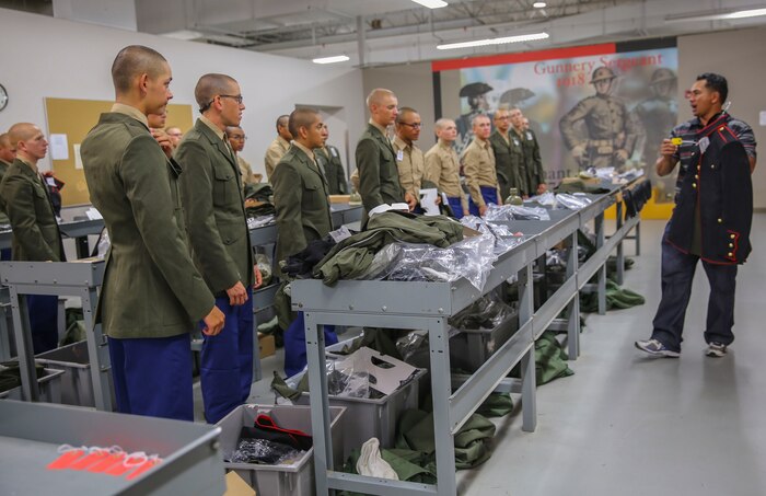 Recruits of Delta Company, 1st Recruit Training Battalion, listen to instructions during their first uniform fitting at Marine Corps Recruit Depot San Diego, Oct. 14. The workers explained to the recruits exactly how the uniform pieces should be labeled for tailoring. Today, all males recruited west of the Mississippi are trained at MCRD San Diego. The depot is responsible for training more than 16,000 recruits annually. Delta Company is scheduled to graduate Nov. 13.
