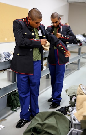Recruits of Delta Company, 1st Recruit Training Battalion, prepare to get their Blue Dress uniform coats tailored during their first uniform fitting at Marine Corps Recruit Depot San Diego, Oct. 14. The coat is paired with the distinguishable blue trousers. Today, all males recruited west of the Mississippi are trained at MCRD San Diego. The depot is responsible for training more than 16,000 recruits annually. Delta Company is scheduled to graduate Nov. 13.