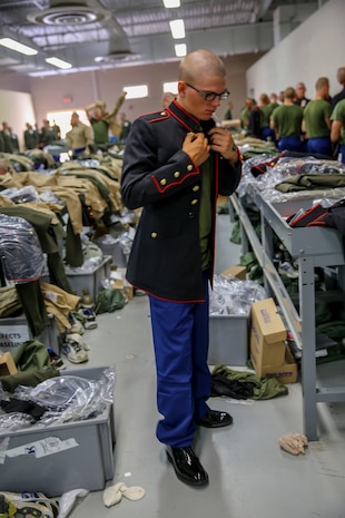 A recruit of Delta Company, 1st Recruit Training Battalion, puts a Blue Dress uniform coat on during his first uniform fitting at Marine Corps Recruit Depot San Diego, Oct. 14. This is the first time the recruits got a chance to try on the uniforms, and they will be returning for a final fitting a couple of weeks before graduation. Today, all males recruited west of the Mississippi are trained at MCRD San Diego. The depot is responsible for training more than 16,000 recruits annually. Delta Company is scheduled to graduate Nov. 13.
