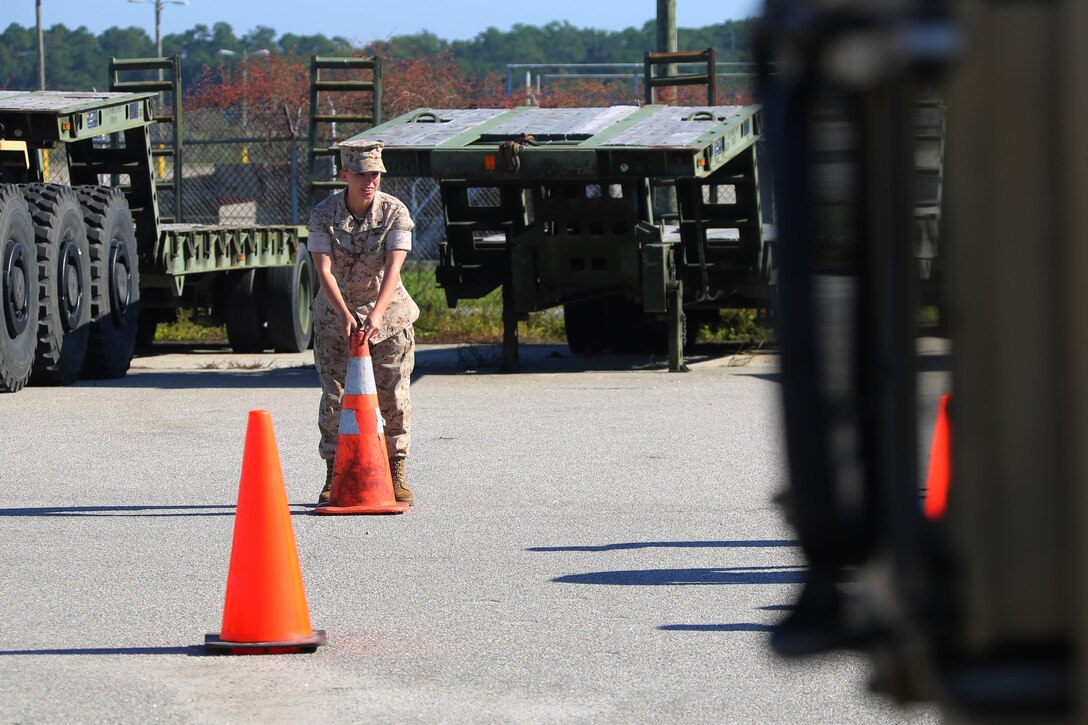 Lance Cpl. Kayla Hershberger prepares a barrier during an Incidental Humvee Licensing Course at Marine Corps Air Station Cherry Point, N.C., Oct. 15, 2015. Marine Wing Support Squadron 274 Marines underwent an extensive course that covered basic operational skills, vehicle capabilities, emergency procedures and first echelon mechanics. The Humvee has many versatile roles throughout the Marine Corps. Taking licensing courses to qualify Marines of different occupational fields helps expand their skill sets while allowing their unit to be more self-sufficient. Hershberger is a field radio operator with the squadron. 
