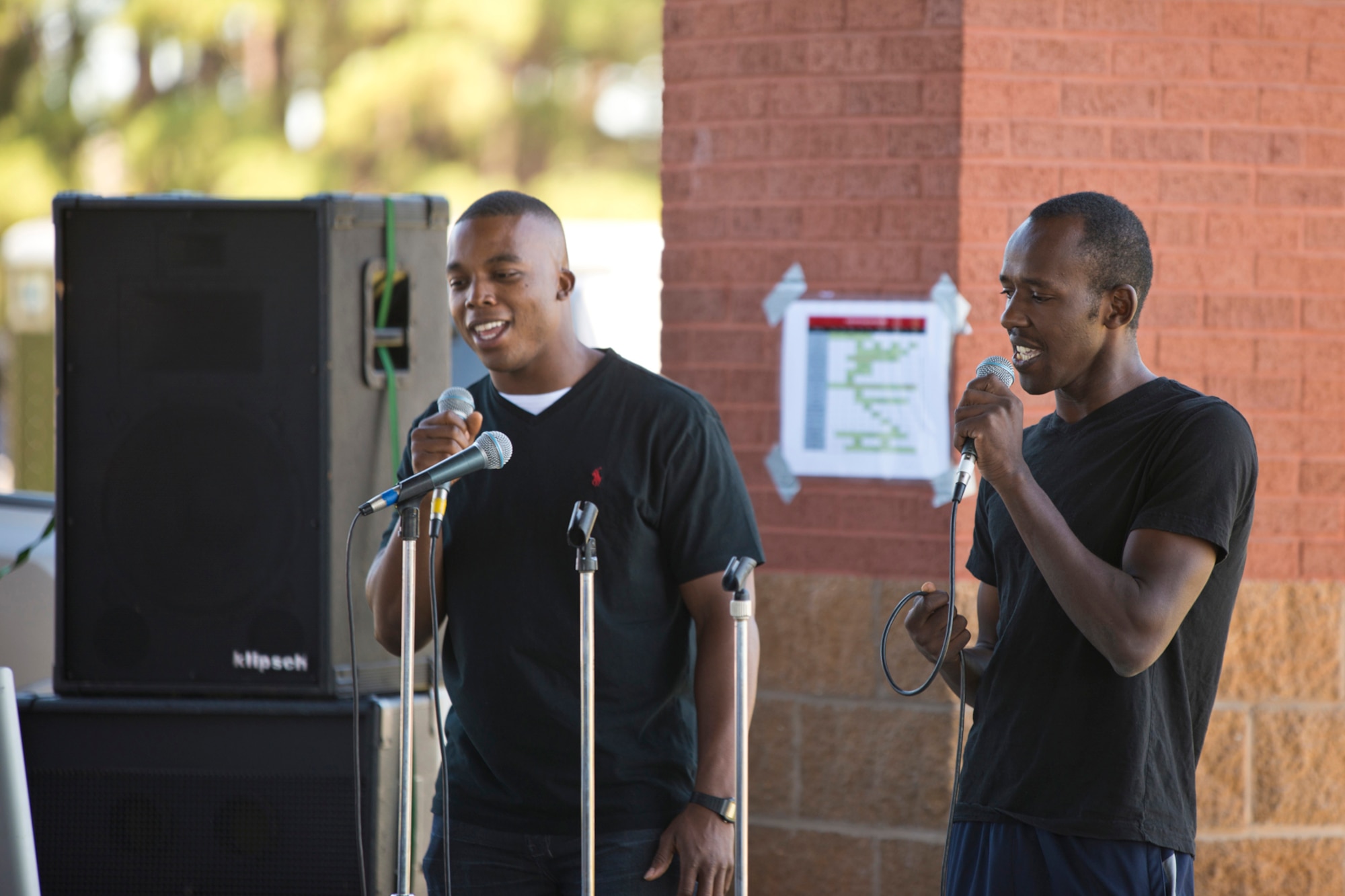 Kelvin Mwaniki (right) and U.S. Air Force Staff Sgt. Marquice Combs, a crew chief assigned to the 913th Maintenance Squadron, wow the crowd with their singing talent during the 913th Airlift Group’s “Family Day” celebration at Little Rock Air Force Base, Ark., Sept. 12, 2015. Mwaniki is currently part of the Development Training Flight at Little Rock AFB, and will be starting Air Force Basic Military Training later this month. (U.S. Air Force photo by Master. Sgt. Jeff Walston/Released)  