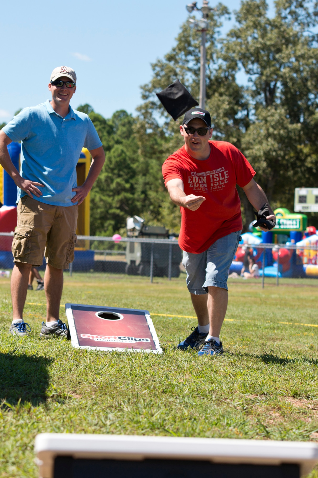 U.S. Air Force Tech. Sgt. James Evans goes for the block during the Bean Bag Toss competition at the 913th Airlift Group’s “Family Day” celebration at Little Rock Air Force Base, Ark., Sept. 12, 2015. Evans is a maintenance operations controller assigned to the 913th Maintenance Squadron at Little Rock AFB. (U.S. Air Force photo by Master. Sgt. Jeff Walston/Released)  