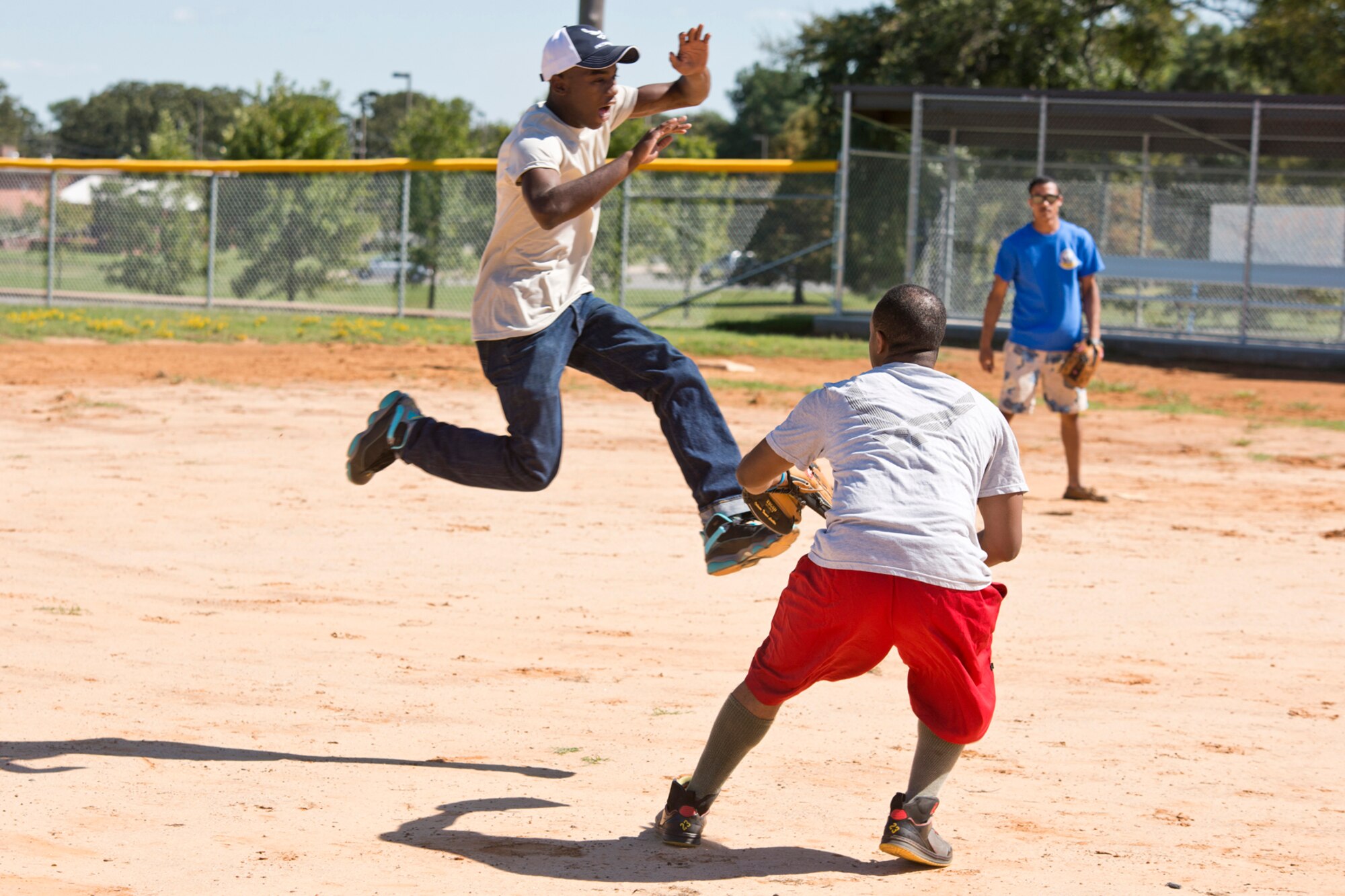 U.S. Air Force Senior Airman Josh Giles tags out Airman 1st Class Chris Dickson, during a friendly game of softball at the Annual 913th Airlift Group’s “Family Day” celebration at Little Rock Air Force Base, Ark., Sept. 12, 2015. Both Airmen are assigned to the 96th Aerial Port Squadron at Little Rock AFB. (U.S. Air Force photo by Master. Sgt. Jeff Walston/Released)  