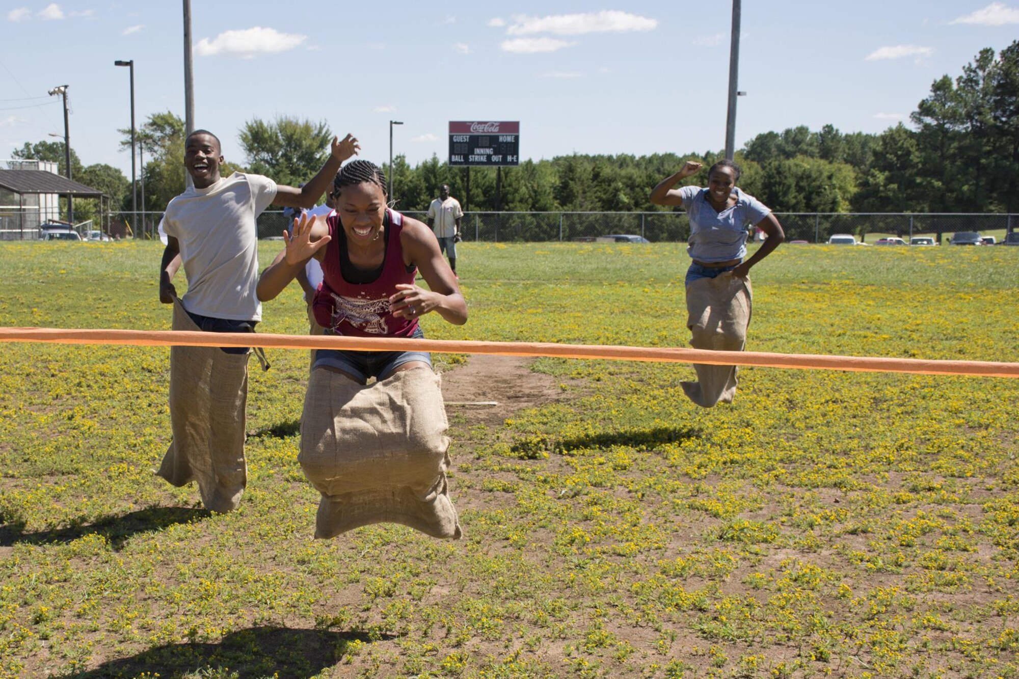 Contestants in the Sack Hop Race go for the finish line at the 913th Airlift Group’s “Family Day” celebration at Little Rock Air Force Base, Ark., Sept. 12, 2015. Approximately 1,000 people participated in the annual event, which promotes taking care of the unit’s family members. The event feature a wide array of events, including a working dog (K-9) demonstration, face painting, softball, bean bag toss and a sack hop race. (Courtesy photo by Eva Walston/Released)  