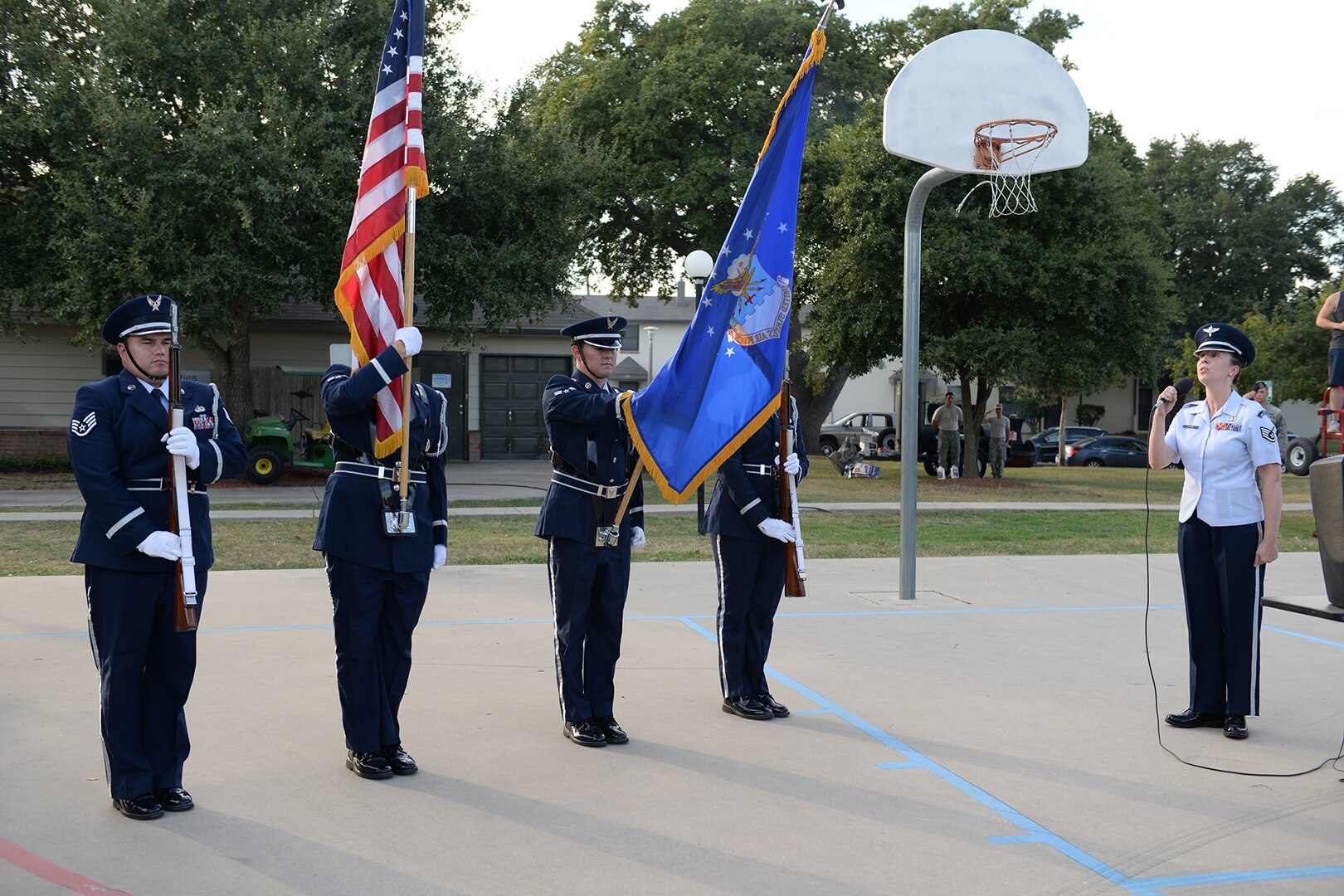The Joint Base San Antonio honor guard presents the colors and sings the national
anthem to kick start the National Night Out Oct. 6, 2015, at JBSA-Lackland, Texas. One of the purposes of the annual event is to enhance relations between the police and community, and increase neighborhood camaraderie. (U.S. Air Force photo by Senior Airman Krystal Wright/Released)