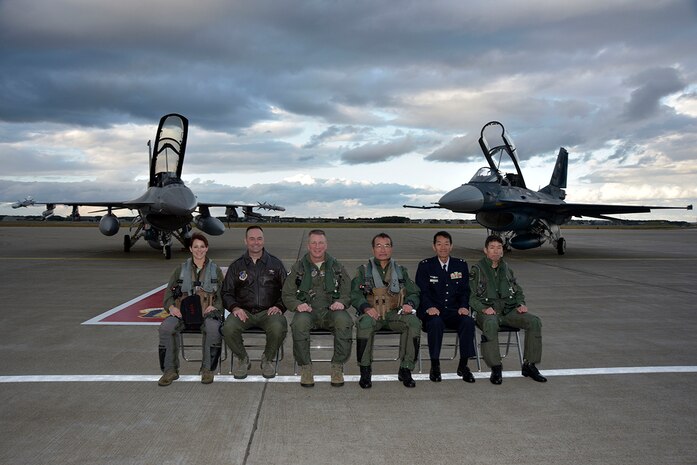 U.S. Air Force Lt. Gen. John L. Dolan, U.S. Forces Japan commander, and Japan Air Self-Defense Force Lt. Gen. Yoshiyuki Sugiyama, Air Defense Command commander (center), pose for a photo alongside base leadership at Misawa Air Base, Japan, Oct. 14, 2015. This followed the conclusion of a bilateral exchange flight by both generals which served as a testament to the strong alliance between U.S. and Japan. 