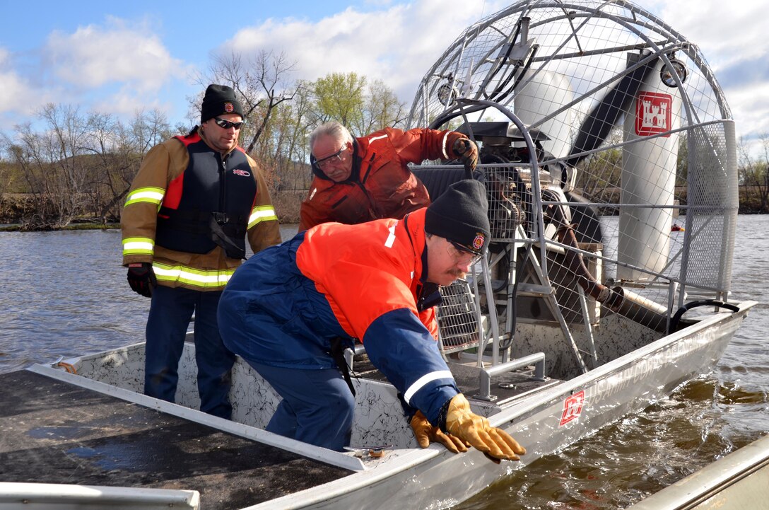 WINONA, Minn., -- From left, Winona, Minn., Fire Department Capt. Duane Chadbourn; Kurt Ressie, U.S. Army Corps of Engineers, St. Paul District, small craft operator; and Dan Cottrell, U.S. Army Corps of Engineers, St. Paul District, channel maintenance coordinator, participate in a joint cold water rescue training event March 28 on the Mississippi River. This was the first time that both agencies trained together and they both plan on making it an annual event.