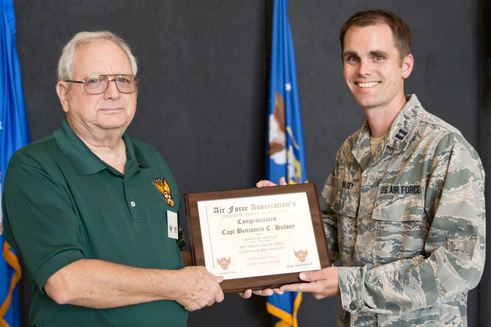 Mr. Jerry Reichenbach presents Capt. Benjamin Hulsey with the 2014 Airman of the Year award for the Air Force Association’s David D. Terry Jr. Chapter, during Commander’s Call at Little Rock Air Force Base, Ark., Sept. 13, 2015. Hulsey is the command post, officer in charge, for the 913th Airlift Group at Little Rock AFB. (U.S. Air Force photo by Master Sgt. Jeff Walston/Released)  