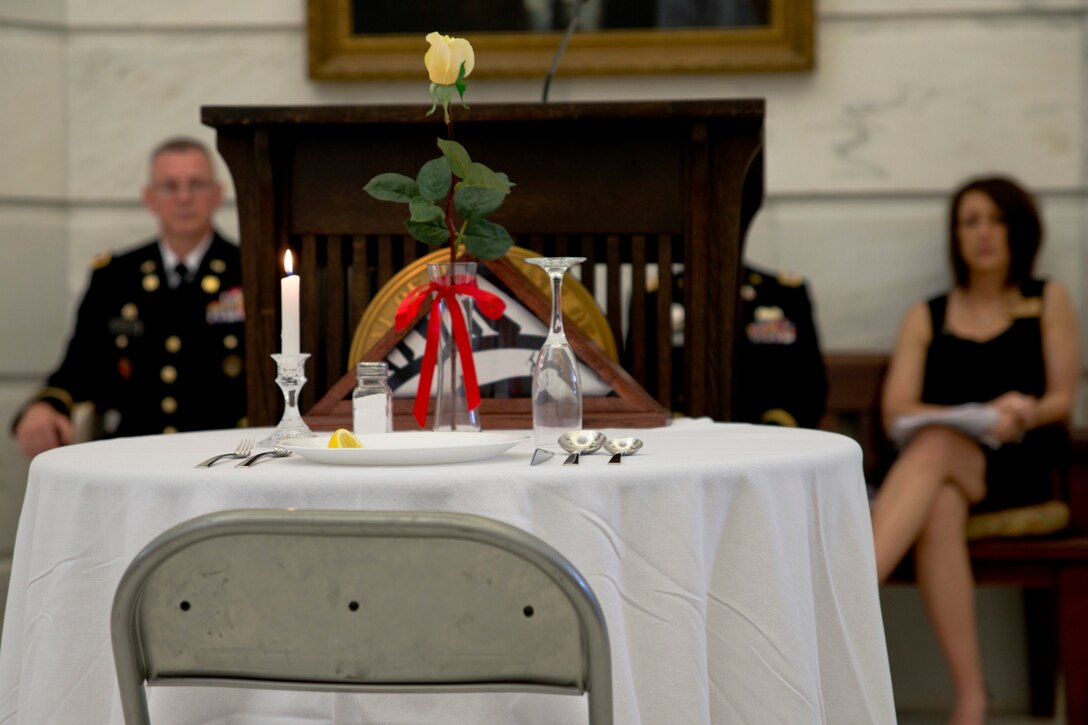 A Missing Man Table sits in a place of honor, near the lectern in the 2nd floor Rotunda of the Little Rock State Capital Building, during the National POW/MIA Recognition Day ceremony, Sept. 18, 2015. The table, set for one, symbolizes the fact that members of the profession of arms are still missing, and the frailty of one prisoner alone against his oppressors. (U.S. Air Force photo by Master Sgt. Jeff Walston/Released)    