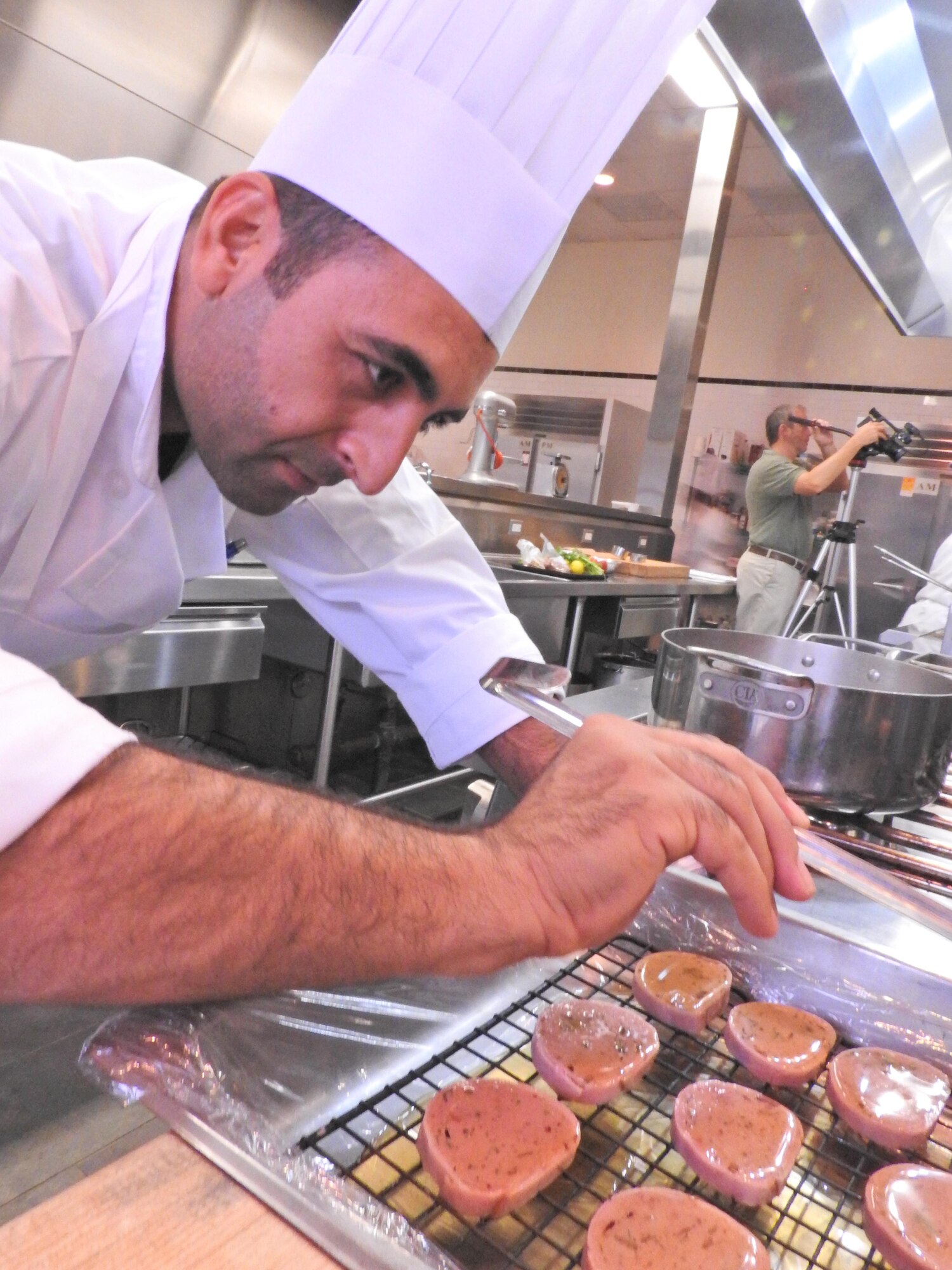 Erdal Akalin, an assistant manager at the Incirlik Air Base Bowling Center in Turkey, carefully applies a glaze to the hors d’oeuvres he prepared during the final day of an advanced culinary skills course offered at the Culinary Institute of America’s San Antonio campus. Akalin was one of 12 Air Force food service personnel who attended the week-long course, Oct. 5-9. The cooperative program, which is managed by the Air Force Services Activity, gives active-duty Air Force and NAF civilian employees the opportunity to hone their skills and learn new ways to improve business operations and efficiency in the kitchen. (U.S. Air Force photo/Breanne Smith/Released)