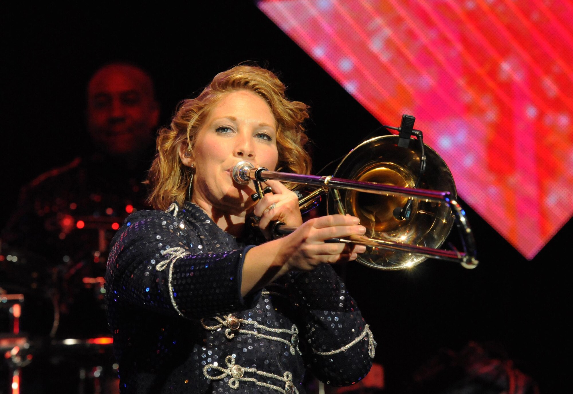 First Lt. Natalie Lane plays the trombone during a performance by Tops in Blue during their 2015 World Tour at the Mississippi Coast Coliseum, Oct. 17, 2015,  Biloxi, Miss. Hundreds of Keesler Airmen, families and community members watched and listened as the sequin-studded members of Tops in Blue performed their diverse show. This year’s tour takes the group to 20 countries with more than 75 performances. For more information on the team or audition requirements, visit www.topsinblue.com. (U.S. Air Force photo by Kemberly Groue)