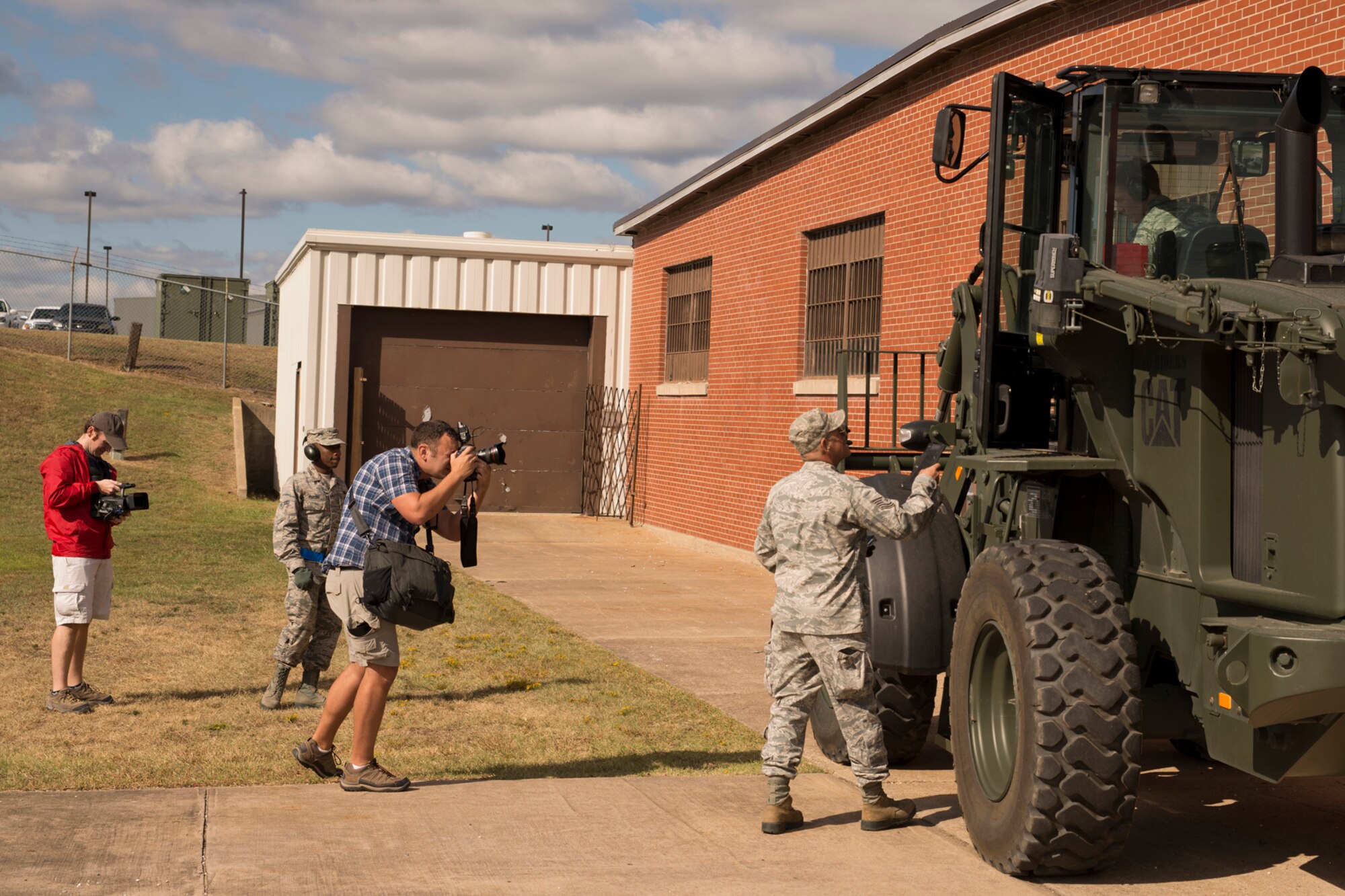 Ramon Purcell photographs members of the 96th Arial Port Squadron prepare for an inspection during the October Unit Training Assembly at Little Rock Air Force Base, Ark., Oct. 3, 0215. Purcell was part of a photography/video team on base to record B-roll, interviews and photographs the Air Force Reserve Command will eventually use for promotional and recruiting purposes. (U.S. Air Force photo by Master Sgt. Jeff Walston/Released)