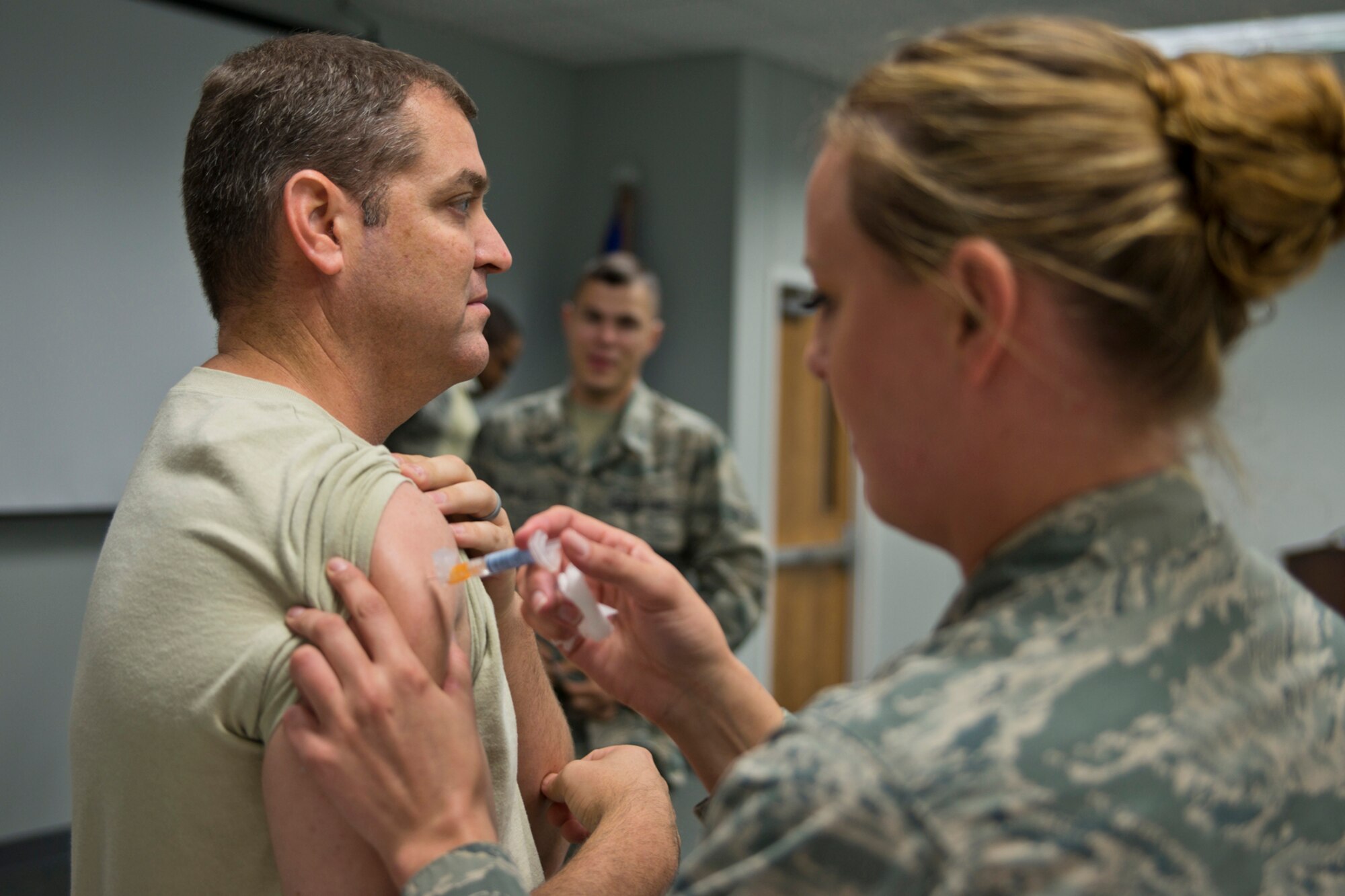 U.S. Air Force Tech. Sgt. Heather Drain, a medical technician assigned to the 913th Aerospace Medical Squadron, inoculates 1st Lt. John Sessoms, executive office, 913th Airlift Group, with the Influenza Vaccine during the October Unit Training Assembly at Little Rock Air Force Base, Ark., Oct. 3, 0215. The U.S. Military vaccinates millions of personnel each year to prevent the spread of a number of contagious diseases. (U.S. Air Force photo by Master Sgt. Jeff Walston/Released)