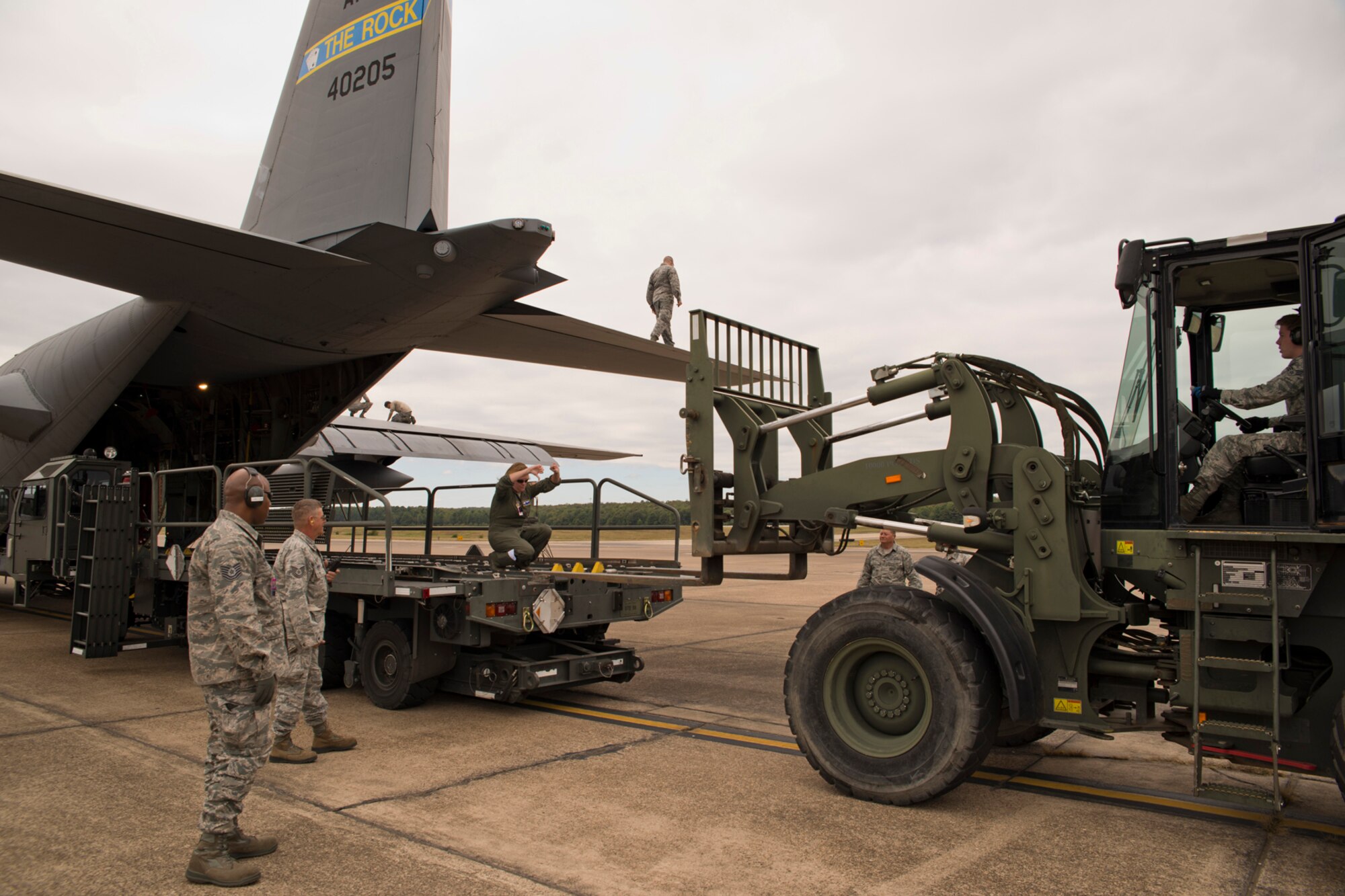 Members of the 96th Aerial Port Squadron and 327th Airlift Squadron, prepare to load cargo onto a C-130H Hercules during the October Unit Training Assembly weekend at Little Rock Air Force Base, Ark., Oct. 3, 0215. The Airmen were participating in Operation MOBEX 2015, which was an aerial port deployment training exercise. (U.S. Air Force photo by Master Sgt. Jeff Walston/Released)