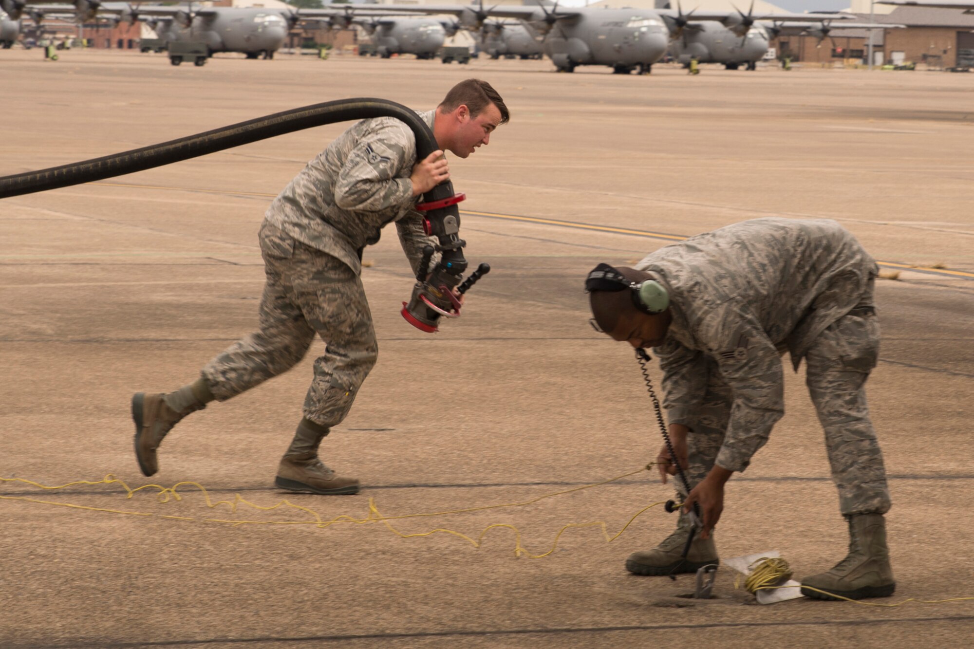 U.S. Air Force Airman 1st Class Austin Voyles, a fuels management technician assigned to the 19th Logistics Readiness Squadron and Senior Airman David Roby, 913th Maintenance Squadron, prepare to refuel a C-130H Hercules at Little Rock Air Force Base, Ark., Oct. 3, 2015. (U.S. Air Force photo by Master Sgt. Jeff Walston/Released)