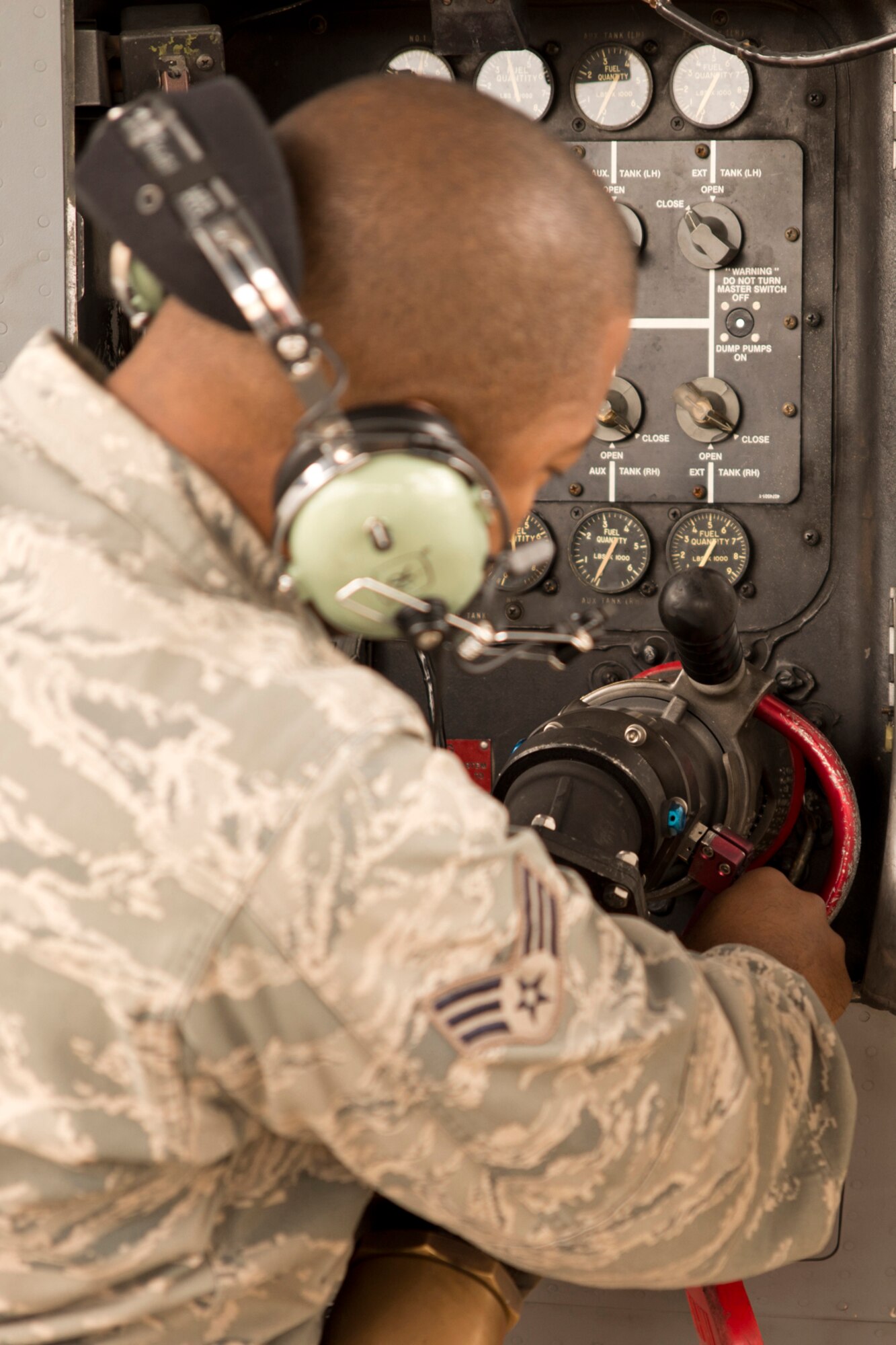 U.S. Air Force Senior Airman David Roby, 913th Maintenance Squadron, attaches a fuel hose to a C-130 Hercules to refuel it at Little Rock Air Force Base, Ark., Oct. 3, 2015. Roby was participating in Operation MOBEX 2015, which was an aerial port deployment training exercise. (U.S. Air Force photo by Master Sgt. Jeff Walston/Released)