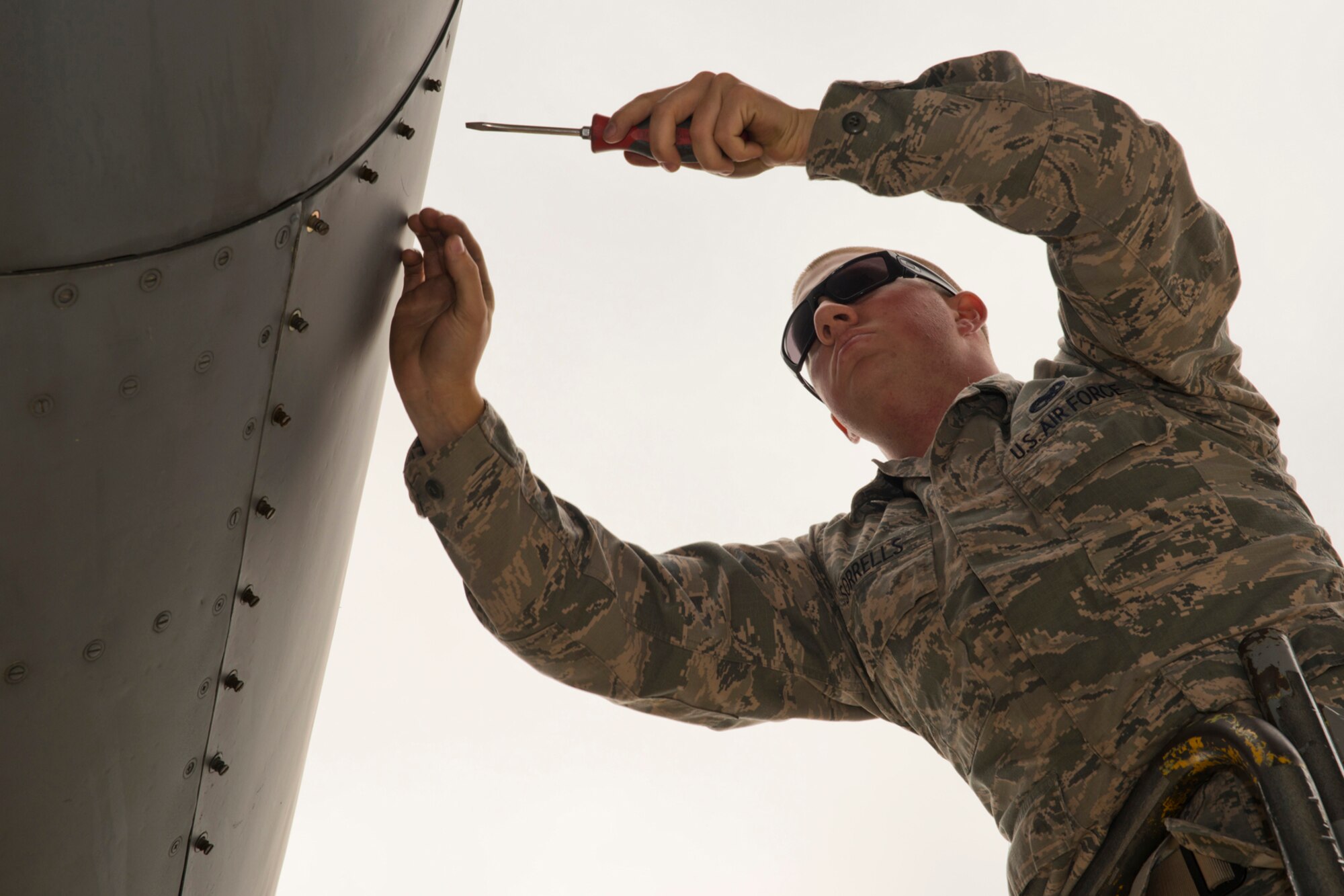 U.S. Air Force Senior Airman Cody Sorrells, crew chief, 913th Maintenance Squadron, tightens a cowling on a C-130H Hercules during a basic post flight inspection at Little Rock Air Force Base, Ark., Oct. 3, 2015. Sorrells was performing his October Unit Training Assembly at Little Rock, which is part of his one weekend a month, two weeks a year commitment to the Air Force Reserve. (U.S. Air Force photo by Master Sgt. Jeff Walston/Released)