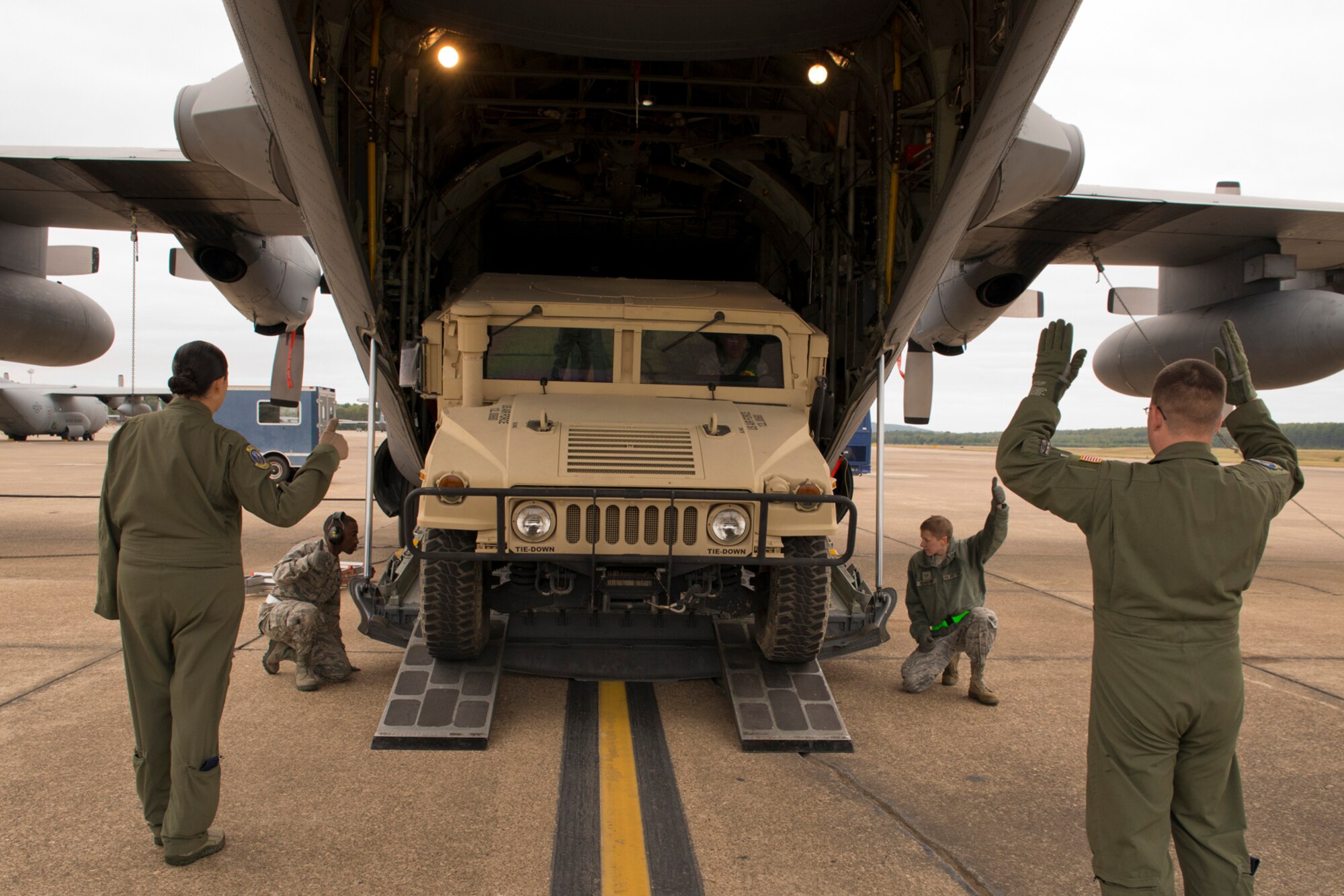U.S. Air Force Tech. Sgt. Dillon Lawrence, an air transportation craftsman assigned to the 96th Aerial Port Squadron, drives a Humvee into the back of a C-130H Hercules at Little Rock Air Force Base, Ark., Oct. 4, 2015. Dillon and the other Airmen were participating in Operation MOBEX 2015, which was an aerial port deployment training exercise. (U.S. Air Force photo by Master Sgt. Jeff Walston/Released)