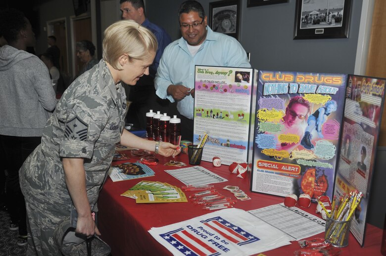 U.S. Air Force Master Sgt. Brenda Dodson, 17th Force Support Squadron first Sergeant reads about the dangers of drugs at the Event Center on Goodfellow Air Force Base Oct. 8, 2015. The drug education booth was for the 5th annual Girl’s Night Out to teach attendees about harmful drugs. (U.S. Air Force photo by Airman Chase Sousa/Released)