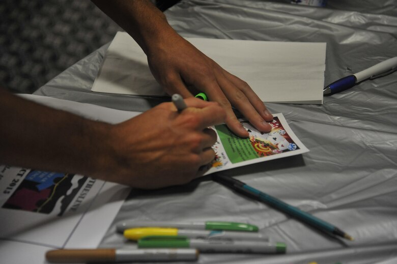 A Girl’s Night Out participant fills out a raffle paper at the Event Center on Goodfellow Air Force Base Oct. 8, 2015. Each participant in the event filled out the paper for a chance to win a random prize. (U.S. Air Force photo by Airman Chase Sousa/Released)
