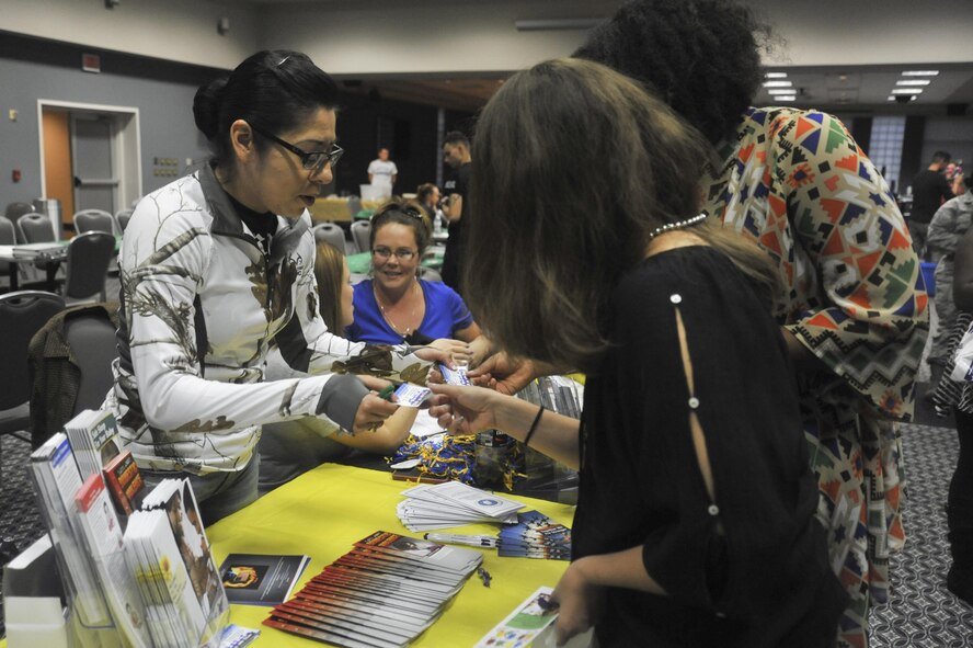 U.S. Air Force Senior Airman Victoria Gutierrez, 17th Medical Operations Squadron Mental Health technician, passes out information on mental health at the Event Center on Goodfellow Air Force Base Oct. 8, 2015. The information was passed out for the 5th annual Girl’s Night Out. (U.S. Air Force photo by Airman Chase Sousa/Released)
