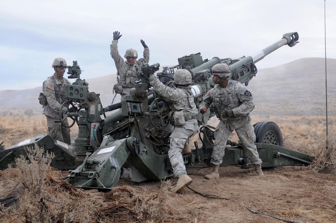 An Army M777 Howitzer crew loads a 155 mm round in preparation for firing during a division artillery readiness test at Yakima Training Center, Wash., Oct. 18, 2015. The test, known as DART, takes place continually over the course of more than 24 hours and tests M777 Howitzer crews on a range of precision skills. The soldiers are assigned to the 2nd Infantry Division’s Battery A, 2nd Battalion, 17th Field Artillery Regiment, 2nd Stryker Brigade Combat Team. Army photo by Capt. Meredith Mathis