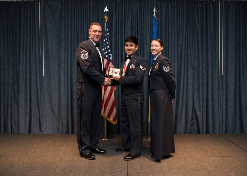 Senior Airman Paolo Pineda from the 92nd Civil Engineer Squadron, receives the Academic Achievement Award during the Airman Leadership School graduation Oct. 15, 2015, at Fairchild Air Force Base, Wash. The Academic Achievement Award is presented to the student with the highest overall average on all academic evaluations. (U.S. Air Force photo/Airman 1st Class Sean Campbell)