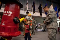 Anthony Martin, son of Tech. Sgt. Miles Martin, 90th Communications Squadron, high-fives Warren’s Fire Department mascot, Flow the Fire Hydrant, Oct. 16, 2015, in the Fall Hall Community Center during the 90th Medical Group’s Health Fair. Sparky the Dog was also at the event. The mascots were provided as entertainment for the children during the event. (U.S. Air Force photo by Lan Kim)