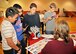 Seventh grade students partner up with a simulated roommate to figure out which living conditions will accommodate both of them the best during the Credit Union 4 Reality fair at Nathan Twining Elementary and Middle School Oct. 16, 2015, on Grand Forks Air Force Base, North Dakota. Students were given a salary based on their desired profession to spend on essential needs in life. (U.S. Air Force photo by Senior Airman Xavier Navarro/Released)