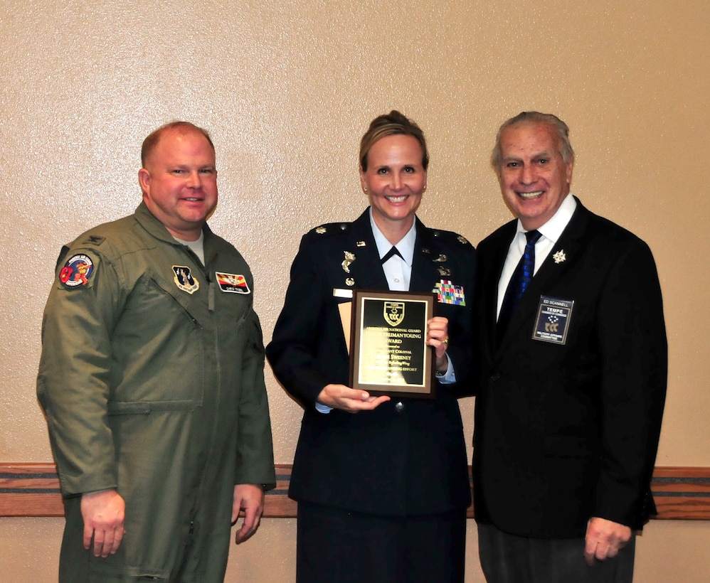 U.S. Air Force Col. Chris Triebel, 161st Air Refueling Wing vice commander, and Edward Scannell, Tempe Military Affairs Committee chair, present the Maj. Truman young award to Lt. Col. Denise Sweeney, security forces commander, during a ceremony Oct. 14, 2015,  at the wing.  (U.S. Air National Guard photo by Master Sgt. Kelly Deitloff) 