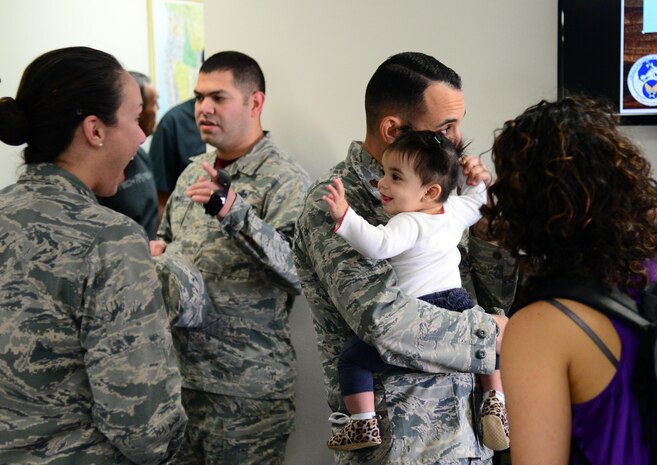 Airmen and their families gather at a reception for the new Airman and Family Readiness Center Oct. 16, 2015, at Malmstrom Air Force Base, Mont. The A&FRC focuses on offering programs to improve life for both Airmen and their dependents. (U.S. Air Force photo/Airman 1st Class Magen M. Reeves)