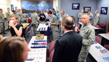 Airmen and their families gather at a reception for the new Airman and Family Readiness Center Oct. 16, 2015, at Malmstrom Air Force Base, Mont. The A&FRC had a ribbon cutting ceremony attended by nearly 100 people and a reception after to bring together the attendees in a relaxed and invited environment. (U.S. Air Force photo/Airman 1st Class Magen M. Reeves)