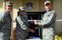A ribbon cutting ceremony is held for the new Airman and Family Readiness Center Oct. 16, 2015, at Malmstrom Air Force Base, Mont. Col. Tom Wilcox, 341st Missile Wing commander, right, Col. Denise Cooper, 341st Mission Support Group commander, center, and Maj. Michael Epper, 341st Force Support Squadron commander, cut the ribbon. (U.S. Air Force photo/Airman 1st Class Magen M. Reeves)
