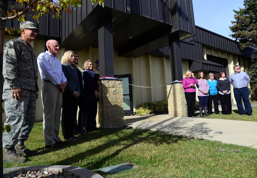Wing leadership and staff celebrate the ribbon cutting of the new Airman and Family Readiness Center Oct. 16, 2015, at Malmstrom Air Force Base, Mont. The A&FRC is run by a ten-member staff of mostly civilians who service not only base personnel, but the entire state of Montana’s military affairs members. (U.S. Air Force photo/Airman 1st Class Magen M. Reeves)