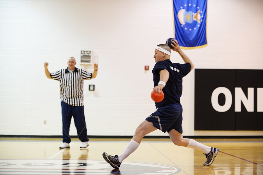 U.S. Air Force Chief Master Sgt. Craig Smith, 509th Maintenance Squadron low observable superintendent, throws a ball toward members of the “Eagles” during a dodgeball game on Wingman Day, Oct. 9, 2015 at Whiteman Air Force Base, Mo.  Events were held throughout the day to inform and educate Airmen about available resources and the importance of resiliency. (U.S. Air Force photo by Tech. Sgt. Miguel Lara III/Released)