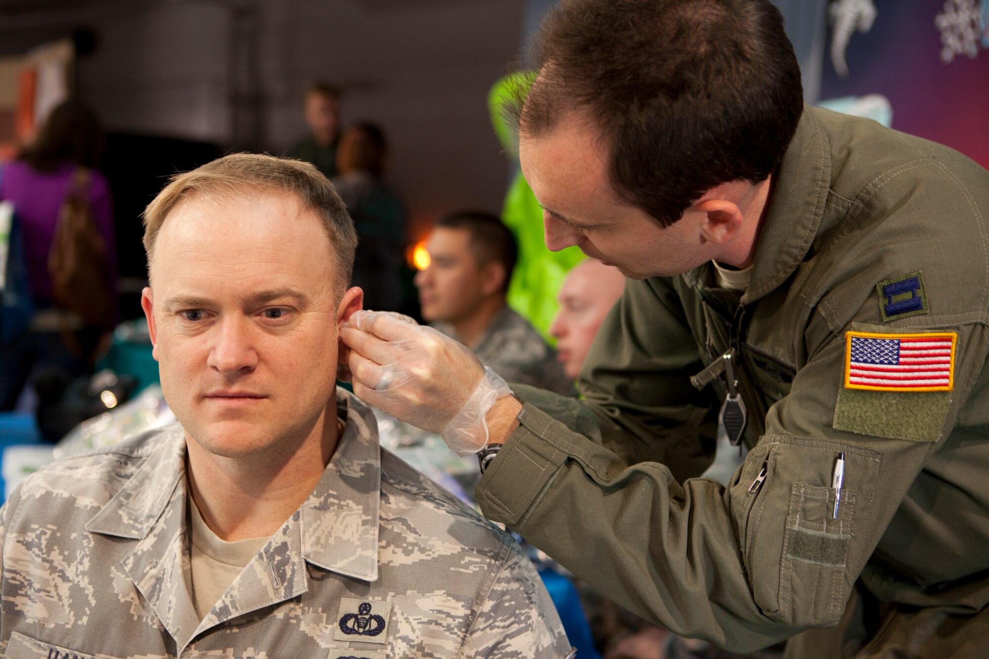 Capt. Ryan Voth, 90th Medical Operations Squadron, performs acupuncture on Master Sgt. Shawn Hanke, 90th Missile Wing Command Post, Oct. 16, 2015, in the Fall Hall Community Center during the 90th Medical Group’s Health Fair. Various booths were available for visitors to interact with and gain more information; some booths provided information on the Medical Group’s services, safety tips and local agencies. (U.S. Air Force photo by Lan Kim)