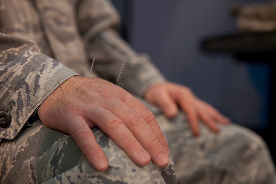 Master Sgt. Shawn Hanke, 90th Missile Wing Command Post, undergoes acupuncture, Oct. 16, 2015, in the Fall Hall Community Center during the 90th Medical Group’s Health Fair. Many services were provided at the event, including a car seat safety booth, CPR demonstrations and flu shots. (U.S. Air Force photo by Lan Kim)