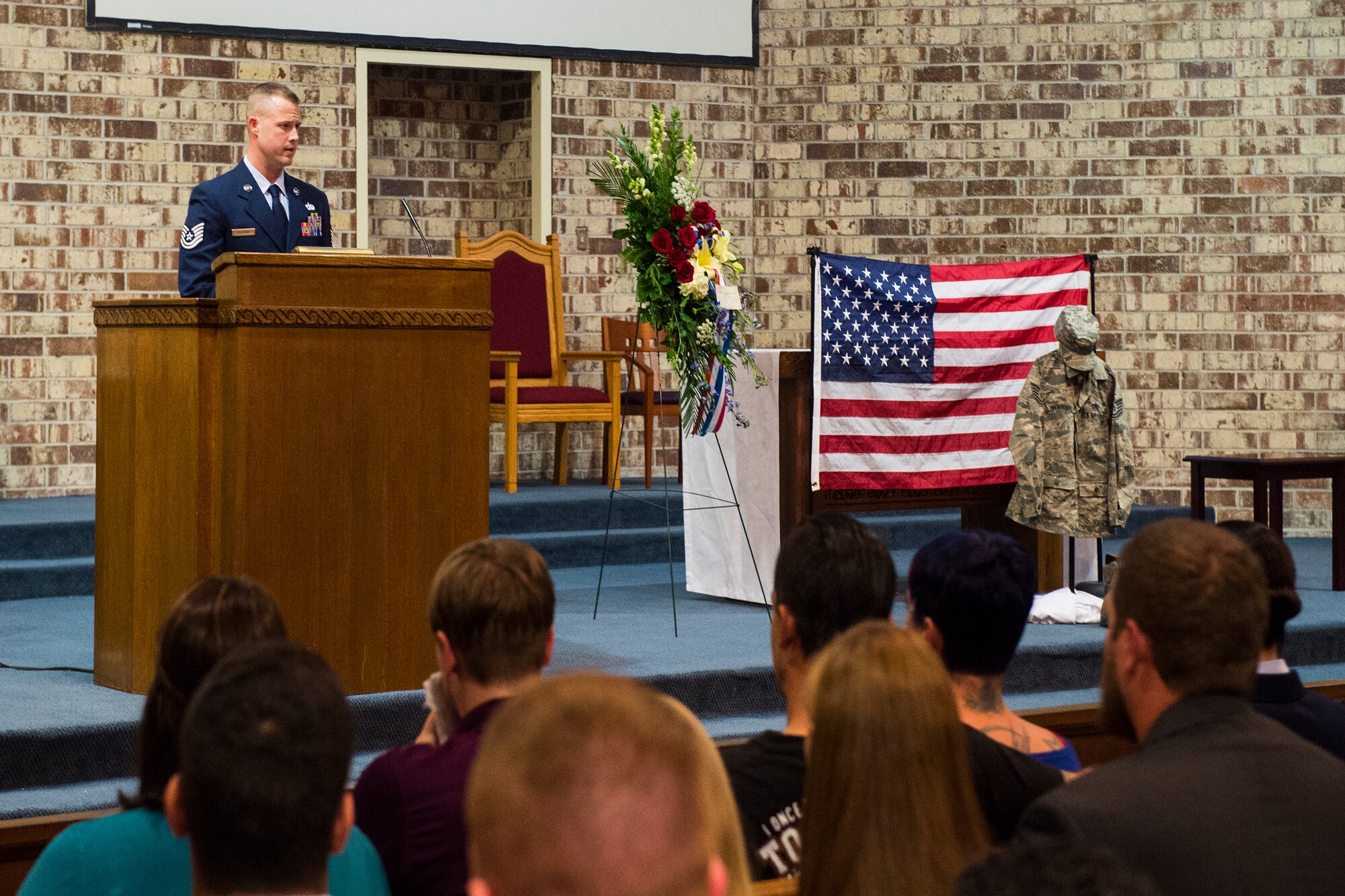 U.S. Air Force Tech. Sgt. Michael Sessions, 723d Aircraft Maintenance Squadron assistant first sergeant, addresses Airman, family and friends in attendance during Tech. Sgt. Marissa Hartford’s memorial ceremony at the base chapel Oct. 16, 2015, at Moody Air Force Base, Ga. Sessions emphasized what an honor it was to serve alongside Hartford and the mark she left on his life and others. (U.S. Air Force Senior Airman Ceaira Tinsley/Released)
