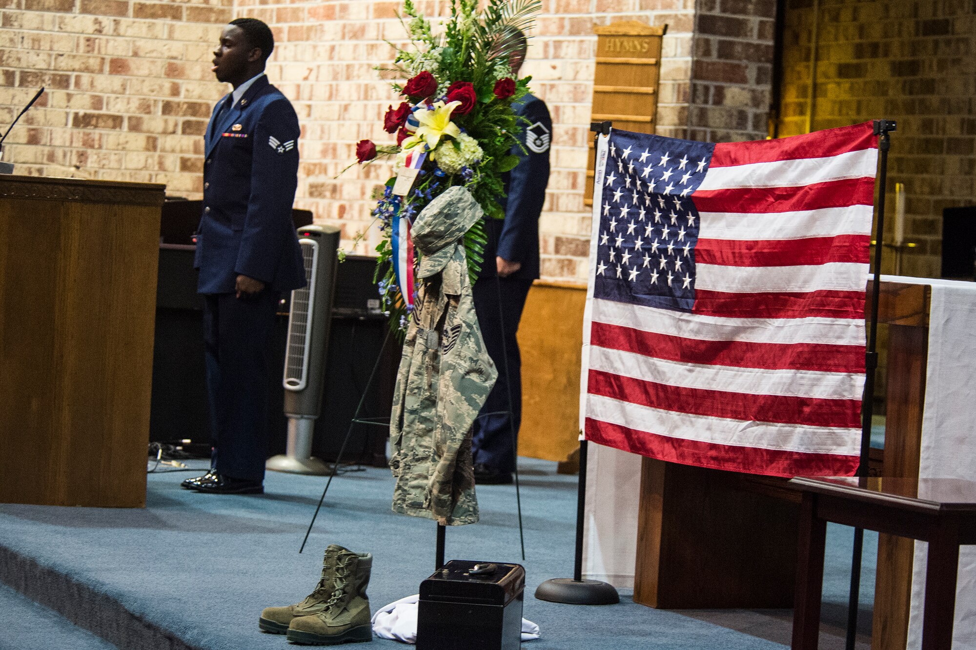 U.S. Air Force Senior Airman Antwaun Snipe,  23d Logistics Readiness Squadron, sings during Tech. Sgt. Marissa Hartford’s memorial ceremony at the base chapel Oct. 16, 2015, at Moody Air Force Base, Ga. Hartford enjoyed karate, snow skiing and horseback riding. She volunteered approximately 700 hours to a local riding organization whose mission is designed to help rehabilitate Department of Defense personnel. (U.S. Air Force Senior Airman Ceaira Tinsley/Released)