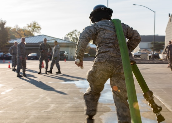 An airman assigned to the 366th Civil Engineer Squadron drags a firehose during the 3rd annual CE Readiness Challenge Oct. 15, 2015 at Mountain Home Air Force Base, Idaho. 10 teams of airmen from various sections of the squadron competed against each other for a shot at first place recognition. (U.S. Air Force photo by Airman 1st Class Connor J. Marth)