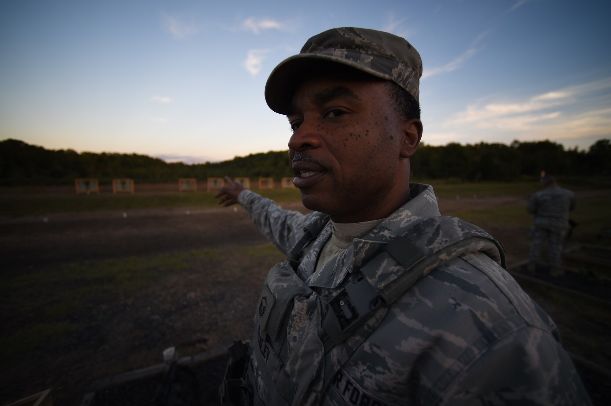 Master Sgt. Cedric Bausley, 188th Security Forces Squad Leader, comments on the visibility of targets down range during night fire qualification on the M4 carbine rifle, Oct. 3, 2015 at Fort Chaffee Joint Maneuver Training Center, Ark. Annual marksmanship training helps to ensure SFS Airman remain proficient with their service weapons. (U.S. Air National Guard photo by Tech. Sgt. Chauncey Reed/Released)