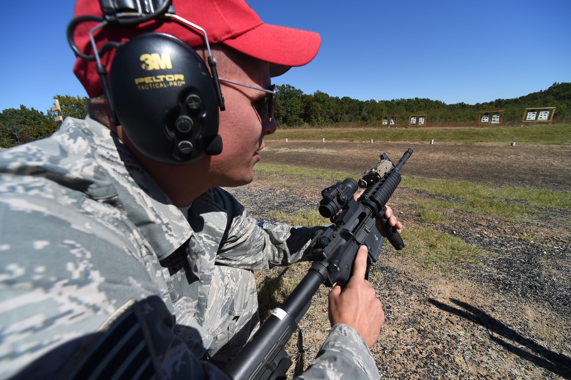 Tech. Sgt. Derek Nietert, 188th Security Forces Combat Arms Training Maintenance instructor, demonstrates firing positions for M4 carbine rifle during weapons qualification at Fort Chaffee Joint Maneuver Training Center, Ark., Oct. 3, 2015. Combat arms instructors serve the entire installation by maintaining range safety certifications and are capable of conducting marksmanship training for all Airmen on the M4 carbine rifle, M-9 pistol and M-16. Annual marksmanship training helps to ensure SFS Airman remain proficient with their service weapons. (U.S. Air National Guard photo by Tech. Sgt. Chauncey Reed/Released)
