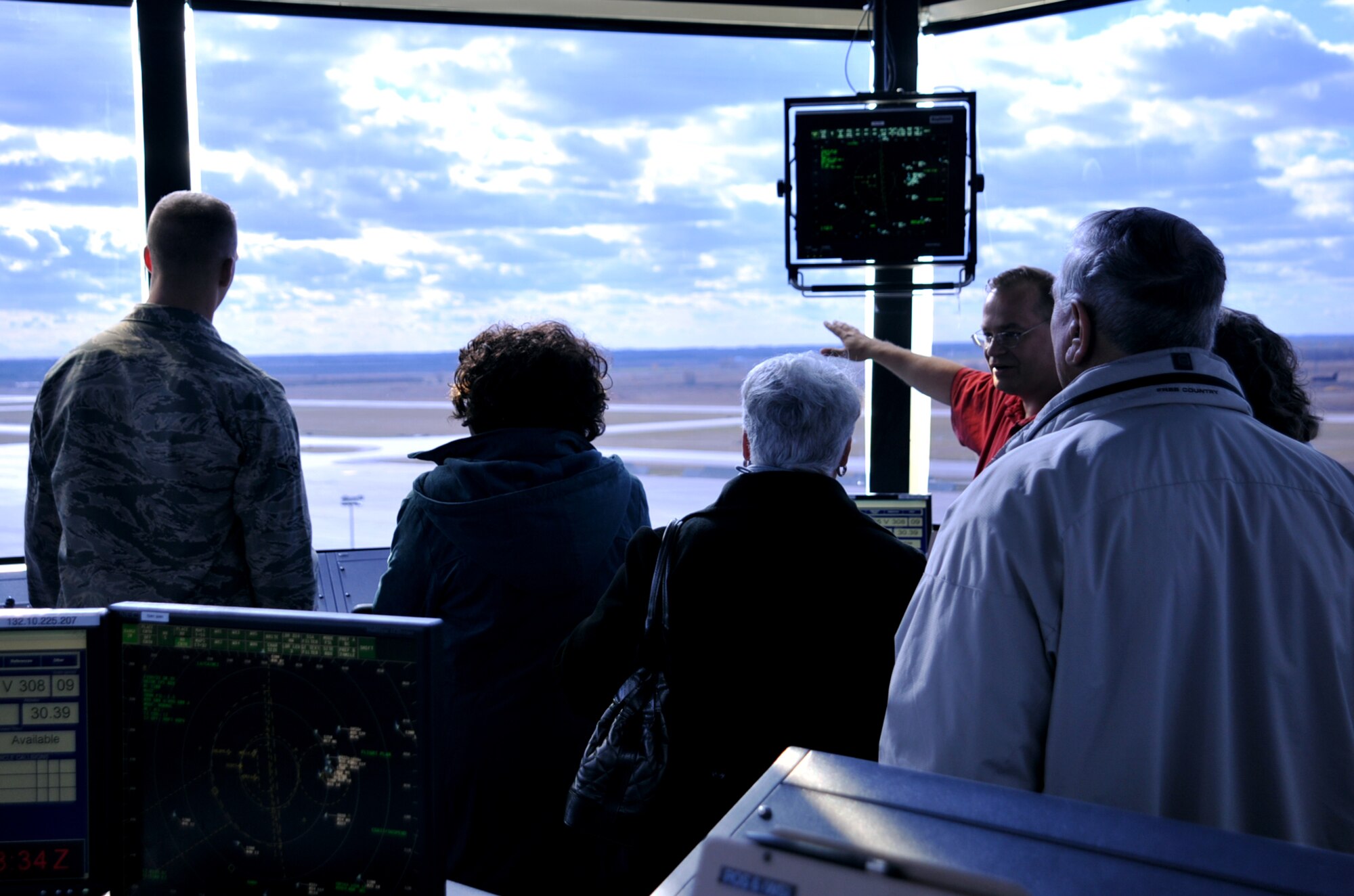 Military retirees enjoy the view from the air traffic control tower on Grand Forks Air Force Base, North Dakota, Oct. 16, 2015. About 40 retirees visited the base to participate in the Retiree Appreciation Day events. (U.S. Air Force photo/Airman 1st Class Bonnie Grantham/Released)
